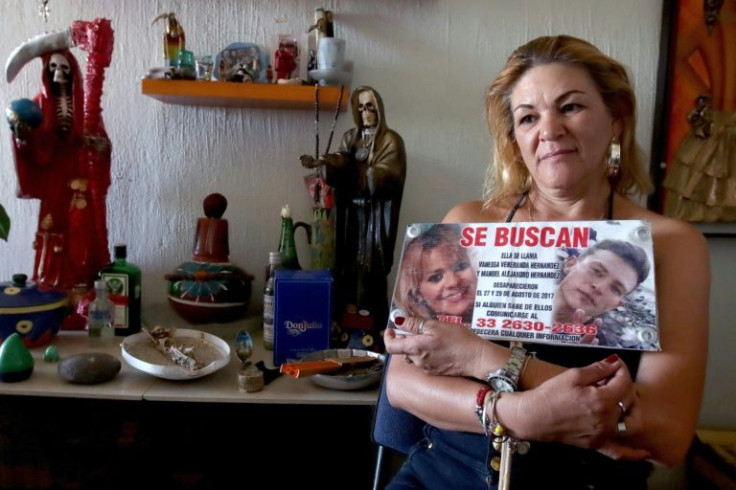 Mexican mother Araceli Hernandez holds a missing persons poster for her daughter Vanessa and son Manuel