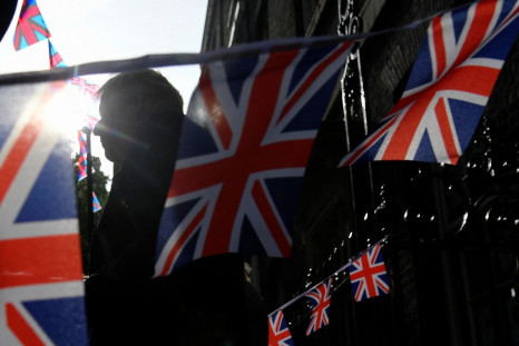 British Prime Minister Boris Johnson talks to stallholders while stood behind British flags, during an event to promote British businesses, at Downing Street, London Britain May 9, 2022. 