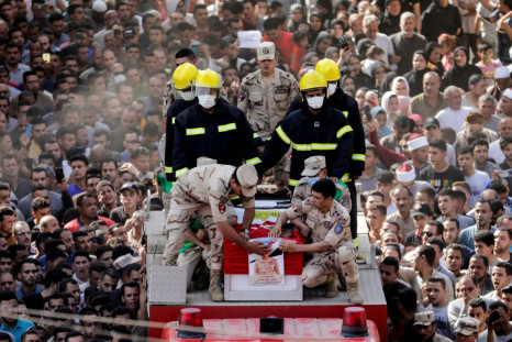 Mourners and soldiers accompany the coffin containing the body of Egyptian officer Soleman Ali Soleman, who was killed in an armed attack claimed by Islamic State on Saturday in Egypt's Sinai peninsula, during a funeral at his home village Jazirat al-Ahra
