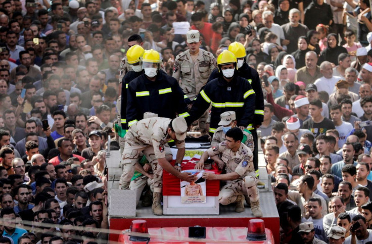 Mourners and soldiers accompany the coffin containing the body of Egyptian officer Soleman Ali Soleman, who was killed in an armed attack claimed by Islamic State on Saturday in Egypt's Sinai peninsula, during a funeral at his home village Jazirat al-Ahra