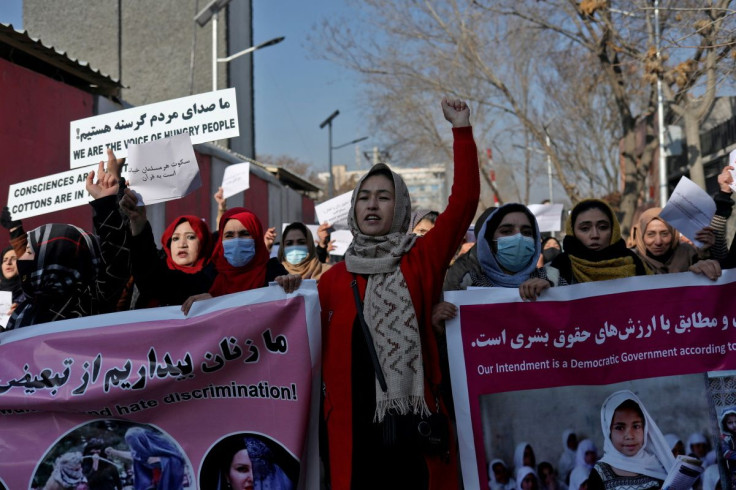Afghan women shout slogans during a rally to protest against what the protesters say is Taliban restrictions on women, in Kabul, Afghanistan, December 28, 2021. 