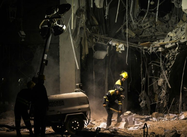 Firefighters and other emergency responders remove debris from the badly damaged hotel in Havana, Cuba