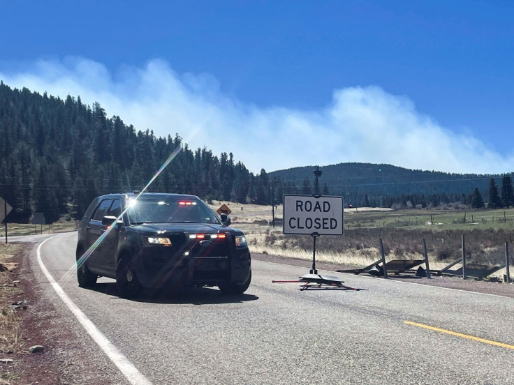 A police roadblock is placed, stopping people entering the area near Holman which is the northern edge of the Hermits Peak Calf Canyon wildfire, near Angostura, New Mexico May 9, 2022.