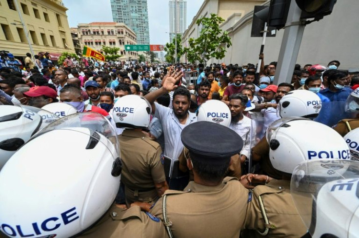 Supporters of Sri Lanka's embattled government faced off with police outside the president's office in the capital Colombo on May 9, 2022