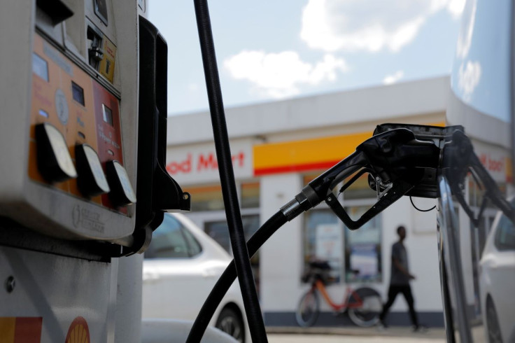 A gas pump is seen in a car at a Shell gas station in Washington, D.C., U.S., May 15, 2021. 