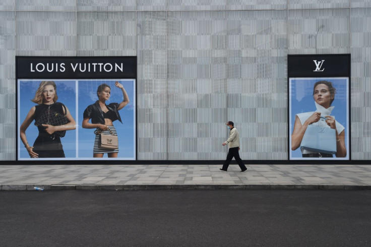 A man wearing a face mask walks past a store of French luxury brand Louis Vuitton at a shopping mall in Wuhan, the epicentre of the novel coronavirus outbreak, Hubei province, China February 25, 2020.