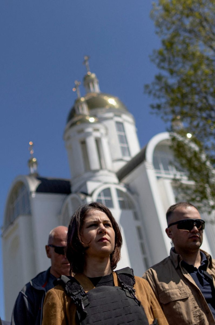 German Foreign Minister Annalena Baerbock visits a church where a mass grave was found after Russian forces retreated from Bucha, as Russia's attack on Ukraine continues, in Bucha, Ukraine May 10, 2022.