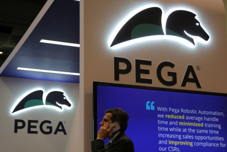 A man talks on the phone under a Pega logo at the Pegasystems booth at the SIBOS banking and financial conference in Toronto, Ontario, Canada October 19, 2017. Picture taken October 19, 2017. 