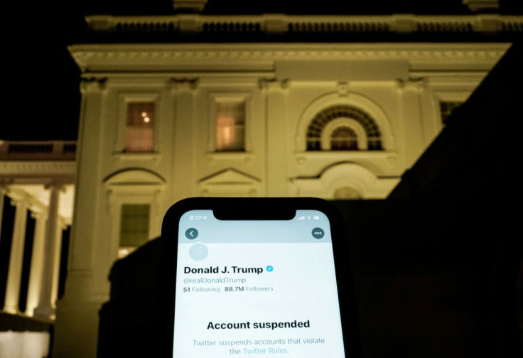 A photo illustration shows the suspended Twitter account of U.S. President Donald Trump on a smartphone and the White House in Washington, U.S., January 8, 2021.  