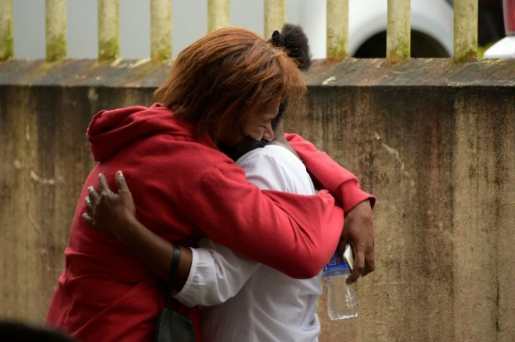 Relatives of an inmate embrace at a coroner's office in Santo Domingo de los Tsachilas, Ecuador, on May 10, 2022, a day after a prison riot left at least 44 inmates dead