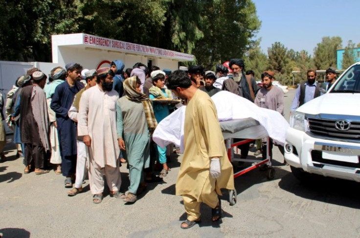 Afghan villagers moving a dead body following an airstrike in Lashkar Gah, Helmand province, in September 2019 that allegedly killed 40 civilians at a wedding celebration.