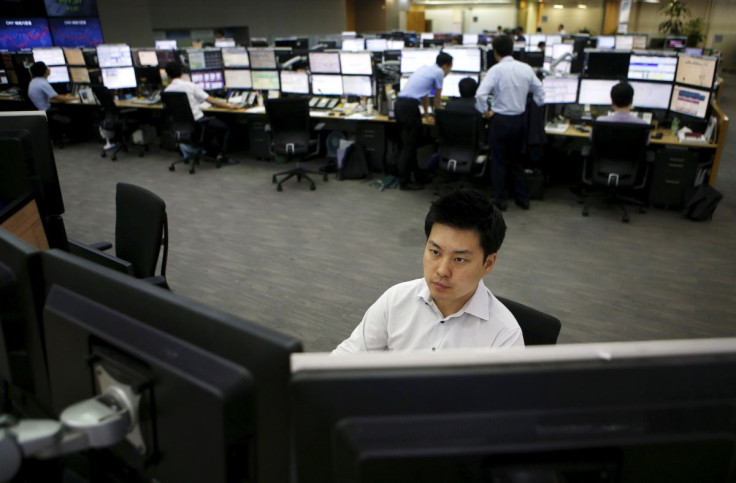 A currency dealer works at a dealing room of a bank in Seoul, South Korea, August 25, 2015.  