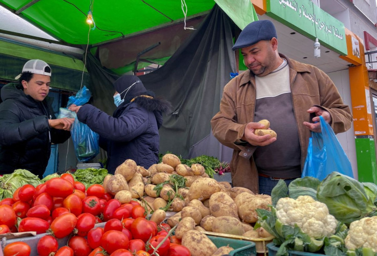 Lotfi Mansouri, a 55-year-old teacher, buys vegetables in Tunis, Tunisia, February 2, 2022.