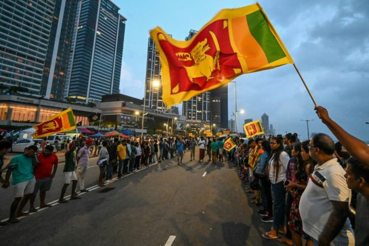 Troops have so far not enforced the curfew at a protest camp in Colombo, where a crowd has gathered to demand the government quit over its mismanagement of the economic crisis