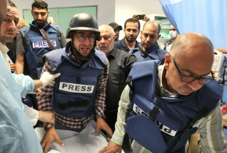 Palestinian cameraman Mujahed al-Saadi weeps as he escorts the body of Al Jazeera reporter Shireen Abu Akleh, who was shot dead as she covered a raid on the West Bank's Jenin refugee camp, on May 11, 2022