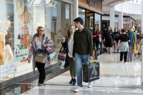 People carrying shopping bags walk inside the King of Prussia shopping mall, as shoppers show up early for the Black Friday sales, in King of Prussia, Pennsylvania, U.S. November 26, 2021.  