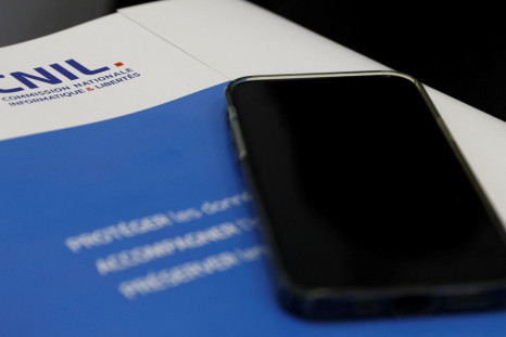 A mobile phone is seen on the annual report of France's data protection watchdog CNIL (Commission Nationale de l'Informatique et des Libertes) during a news conference in Paris, France, May 11, 2022. 
