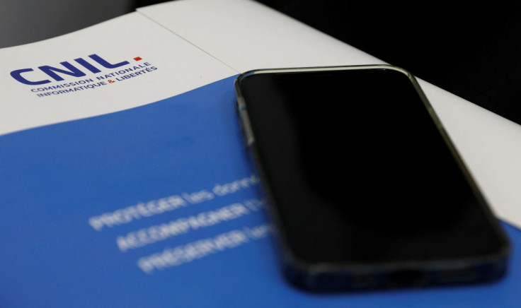 A mobile phone is seen on the annual report of France's data protection watchdog CNIL (Commission Nationale de l'Informatique et des Libertes) during a news conference in Paris, France, May 11, 2022. 