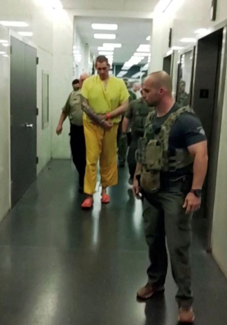 Casey White, a murder suspect who escaped from an Alabama jail, is escorted out of the Lauderdale County Court House, in Florence, Alabama, U.S., May 10, 2022, in this still image from a handout video. Lauderdale County Sheriff's Department/Handout via RE