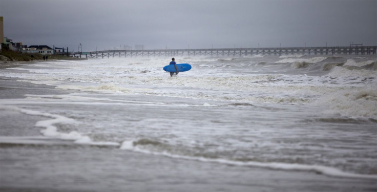 A surfer navigates the wave in Surfside Beach, South Carolina, October 2, 2015.  