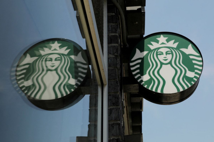 A Starbucks logo hangs outside of one of the 8,000 Starbucks-owned American stores that will close around 2 p.m. local time on Tuesday as a first step in training 175,000 employees on racial tolerance in the Brooklyn borough of New York, U.S., May 29, 201