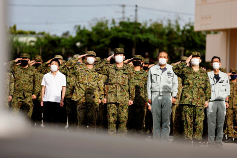 Members of the Japan Ground Self-Defense Force (JGSDF) salute the Japanese national flag during the morning assembly at JGSDF Miyako camp on Miyako Island, Okinawa prefecture, Japan April 21, 2022. Picture taken April 21, 2022. 