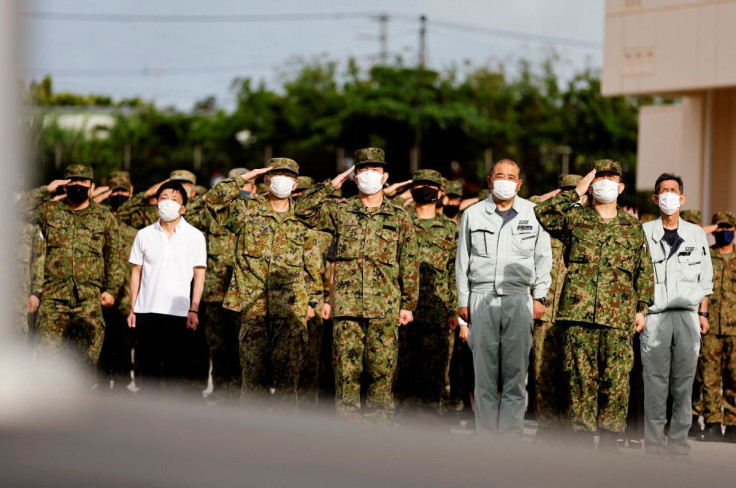 Members of the Japan Ground Self-Defense Force (JGSDF) salute the Japanese national flag during the morning assembly at JGSDF Miyako camp on Miyako Island, Okinawa prefecture, Japan April 21, 2022. Picture taken April 21, 2022. 