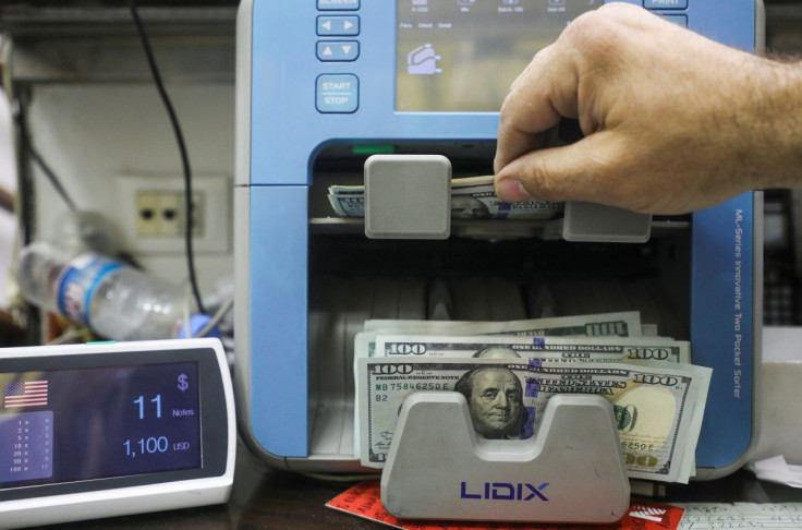 A man counts U.S. dollar banknotes at an exchange shop in Beirut, Lebanon March 18, 2022. 