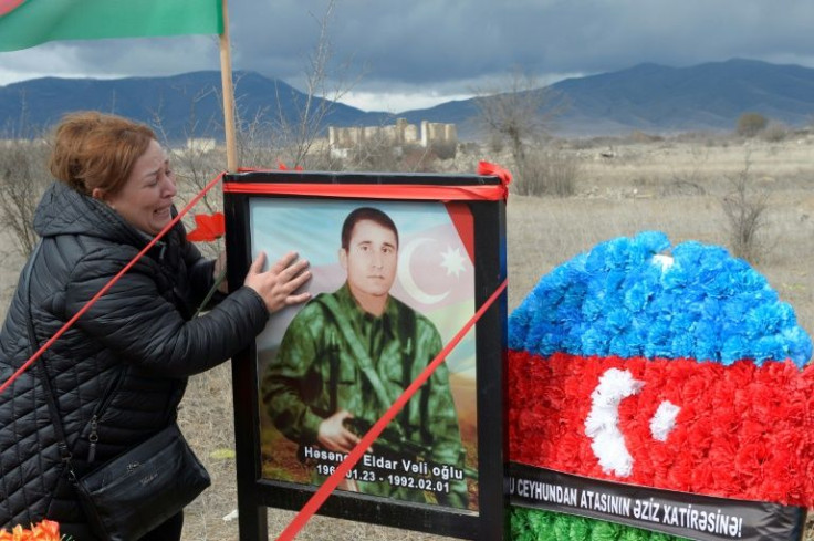 Painful return: Gulbeniz Jafarova, 55, cries at the grave of her brother who died defending Aghdam from Armenian separatists, who held the city for three decades