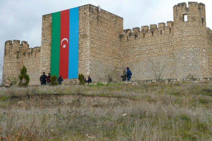 We're back: A huge Azerbaijani flag hangs from Shahbulag castle outside Aghdam as returning refugees visit their former homes