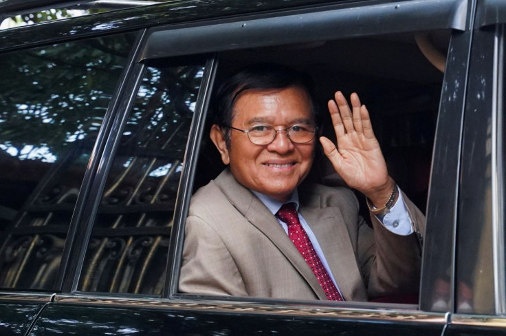Cambodian opposition leader Kem Sokha waves from a vehicle as he leaves his home to attend a hearing on his treason trial in Phnom Penn, Cambodia, January 25, 2022.