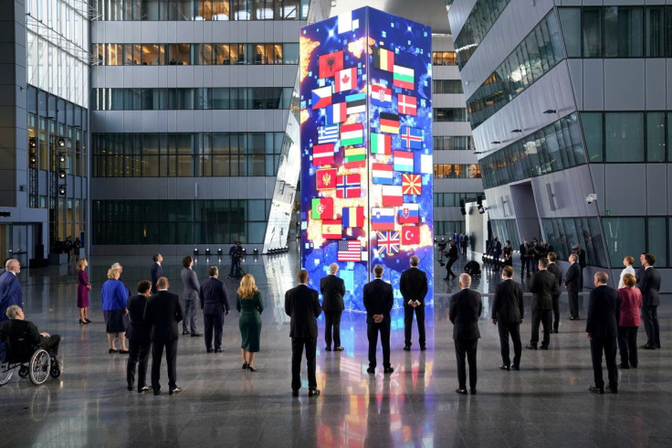 NATO heads of the states and governments look at a digital installation after posing for a family photo, during the NATO summit at the Alliance's headquarters in Brussels, Belgium June 14, 2021.
