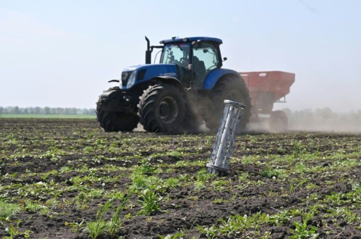 Ukraine farmers, such as this one seen driving past a Russian missile near Kharkiv, have reduced their wheat planting this year.