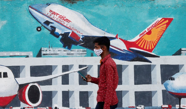 A man walks past a mural of Air India airlines on a street in Mumbai, India, October 19, 2021. 