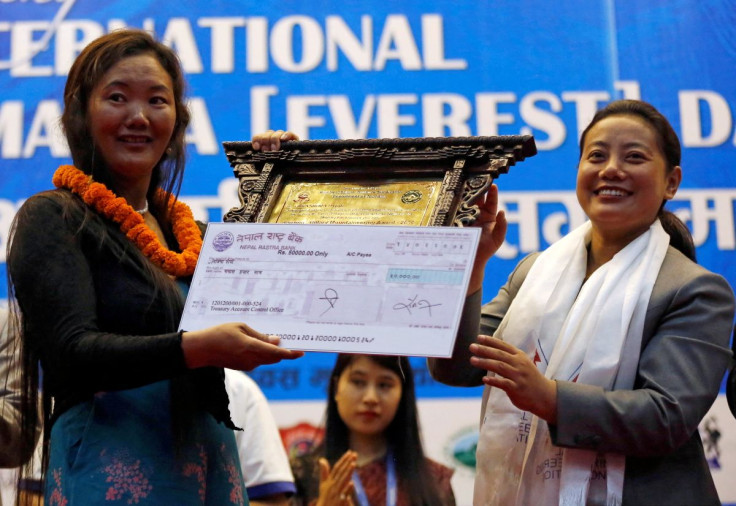 Lhakpa Sherpa, 44, a Nepali mountaineer who climbed Mount Everest 9 times, receives Tenzing à Hillary Mountaineering Award during the function to mark the International Everest day in Kathmandu, Nepal May 29, 2018.