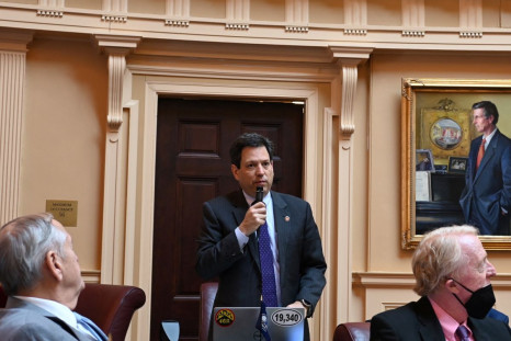 Virginia State Senator Scott Surovell, who sponsored legislation to allow for police use of facial recognition, speaks holding a microphone during a senate session, in Richmond, Virginia, U.S., March 2022.   JoNathan Collins/Handout via REUTERS     