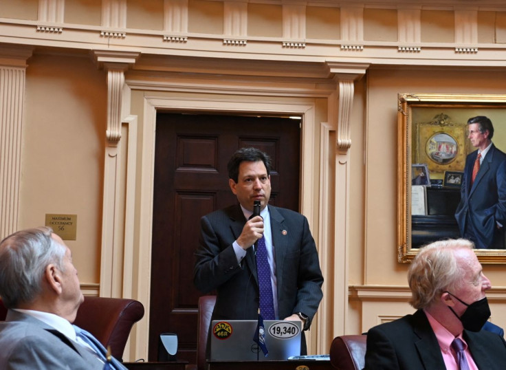 Virginia State Senator Scott Surovell, who sponsored legislation to allow for police use of facial recognition, speaks holding a microphone during a senate session, in Richmond, Virginia, U.S., March 2022.   JoNathan Collins/Handout via REUTERS     