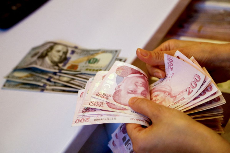 A money changer counts Turkish lira banknotes at a currency exchange office in Ankara, Turkey September 27, 2021. 