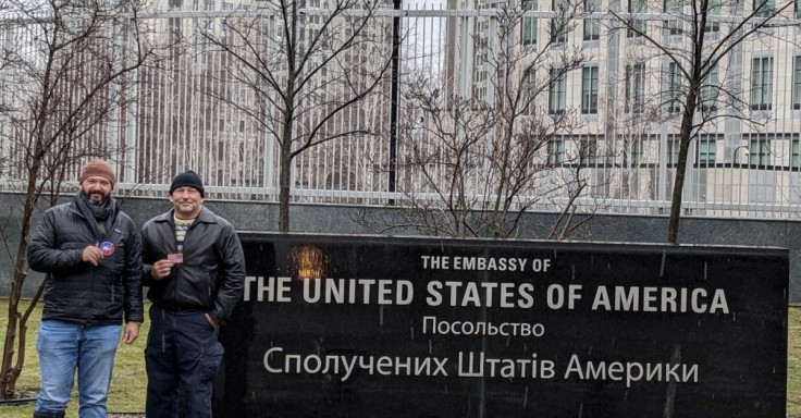 Bryan Stern (left), co-founder and head of on-the-ground operations of Project Dynamo, poses with an unidentified man outside the U.S. Embassy in Kyiv, Ukraine, in this undated handout picture obtained by Reuters February 24, 2022. Project Dynamo/Handout