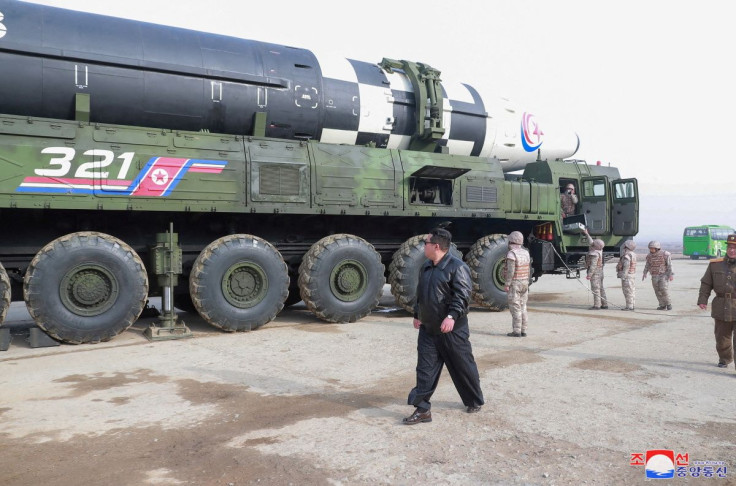 North Korean leader Kim Jong Un walks next to what state media reports is the "Hwasong-17" intercontinental ballistic missile (ICBM) on its launch vehicle in this undated photo released on March 25, 2022 by North Korea's Korean Central News Agency (KCNA).