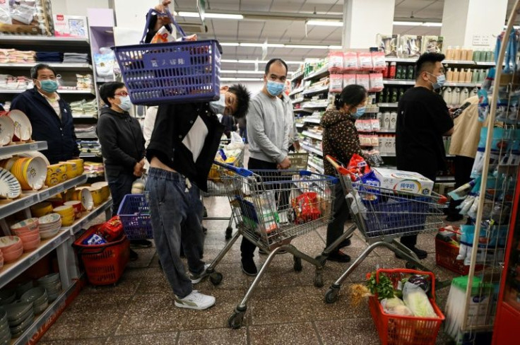 Long lines of shoppers in masks filled supermarket aisles in Beijing