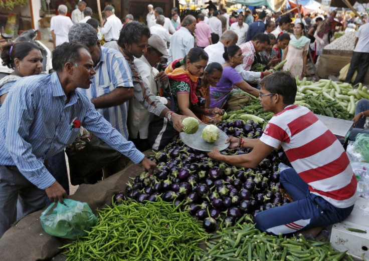 Customers buy vegetables at a market in Ahmedabad, India, September 29, 2015.  