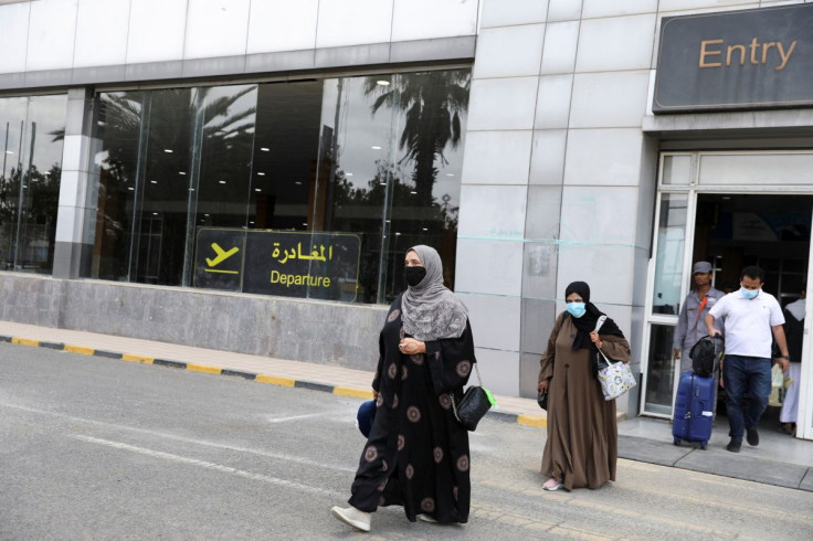 Travellers walk out of Sanaa airport upon their arrival in Sanaa, Yemen April 24, 2022.