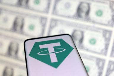 Smartphone with Tether logo is placed on displayed U.S. dollars in this illustration taken, May 12, 2022. 