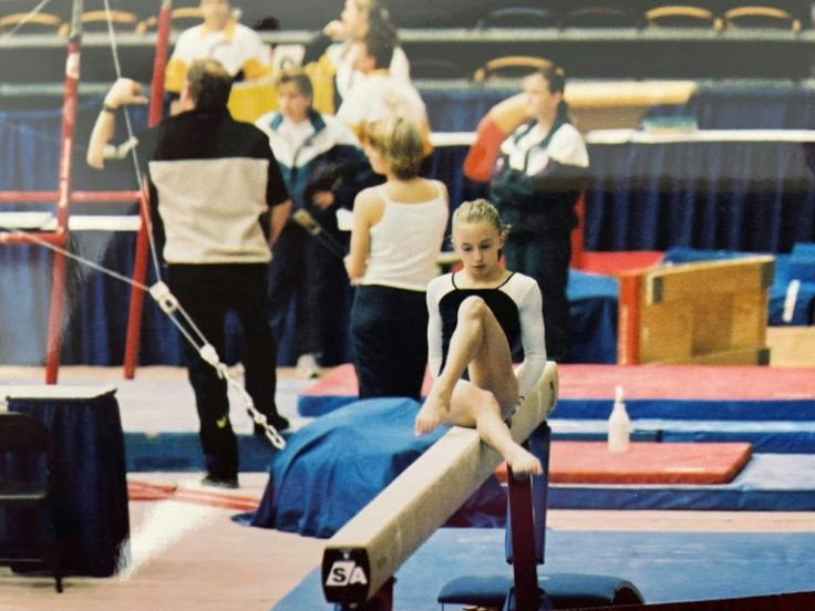 Amelia Cline performs on the balance beam at a national competition in Winnipeg, Canada, in 2002