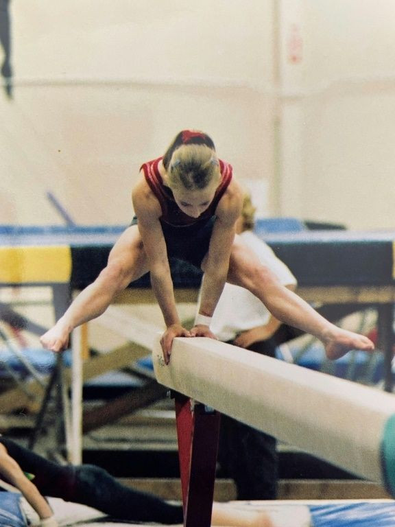 Photo courtesy of Amelia Cline shows her performing a 2002-2003 balance beam move during training in Coquitlam, Canada