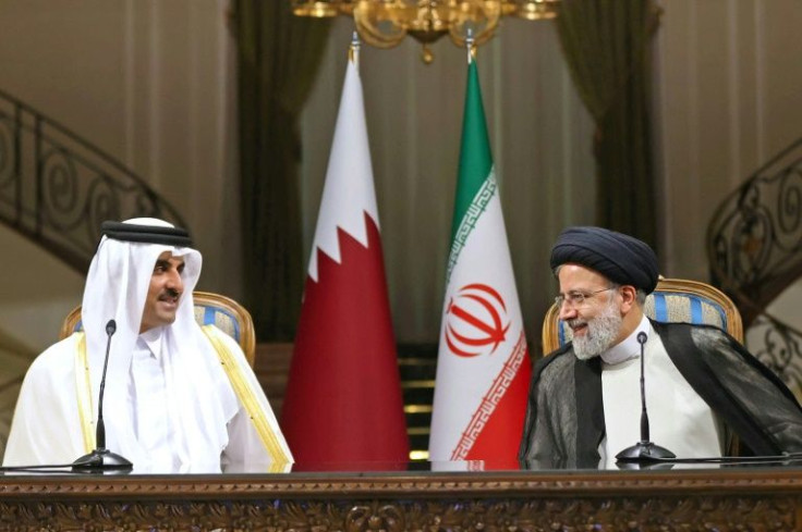 Iran's President Ebrahim Raisi (R) holds a press conference with visiting Qatari Emir Sheikh Tamim bin Hamad Al-Thani -- the Gulf state has added the Iran nuclear dispute to a list of diplomatic issues in which it has quietly mediated