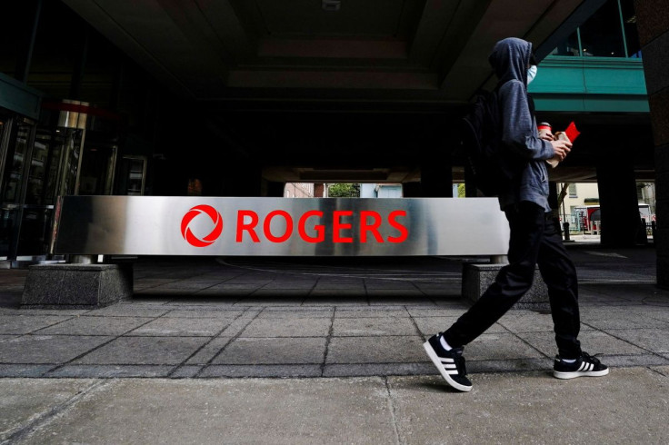 A person walks near the Rogers Communications building in Toronto, Ontario, Canada on October 22, 2021.