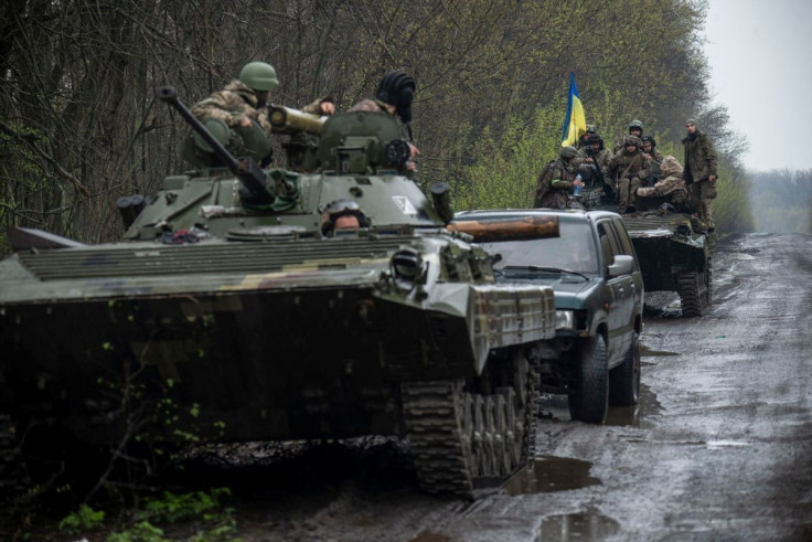 Ukrainian servicemen sit atop an armoured fighting vehicle, as Russia?s attack on Ukraine continues, at an unknown location in Eastern Ukraine, in this handout picture released April 19, 2022.  Press service of the Ukrainian Ground Forces/Handout via REUT