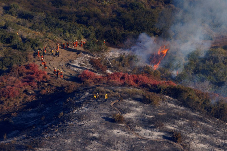 Fire fighting crews work to contain the Coastal Fire, a wild fire in Laguna Niguel, California, U.S., May 12, 2022.  